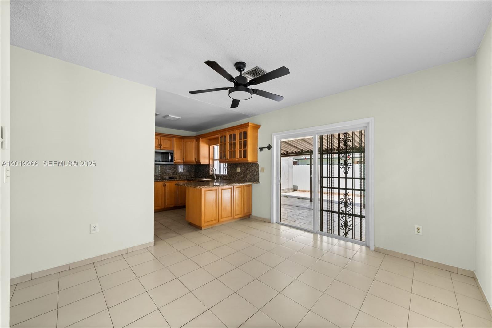 13 Southwest 97th Place Miami, FL 33174 - Photo 7 of 29 a view of kitchen with furniture ceiling fan and window