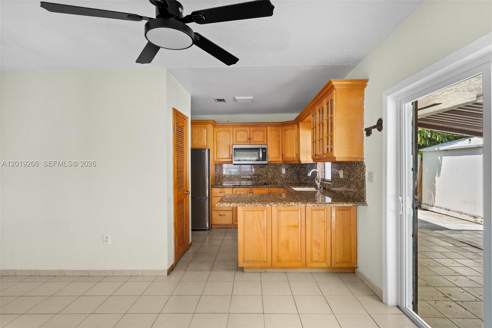 13 Southwest 97th Place Miami, FL 33174 - Photo 8 of 29 a kitchen with stainless steel appliances kitchen island granite countertop a refrigerator and a sink