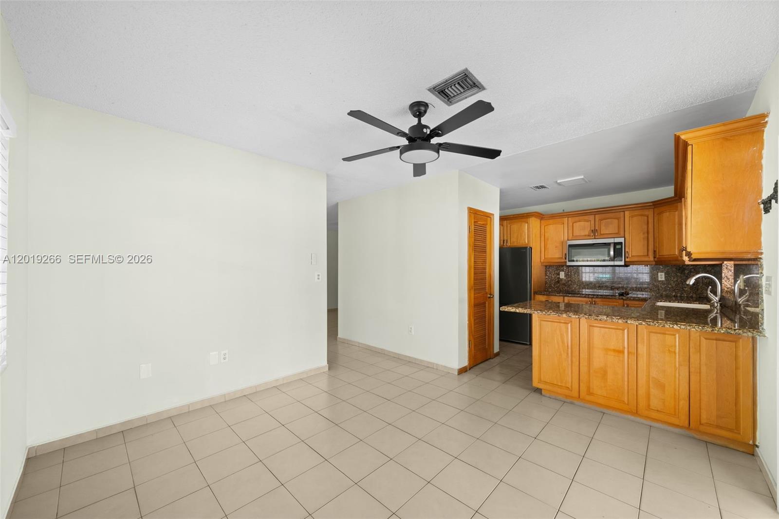 13 Southwest 97th Place Miami, FL 33174 - Photo 9 of 29 a kitchen with stainless steel appliances granite countertop a refrigerator and a sink