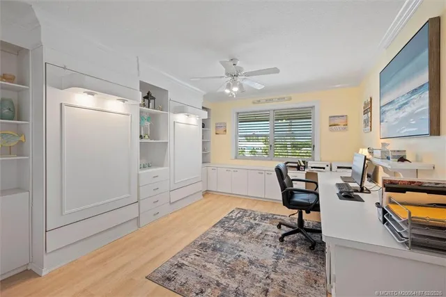a bedroom with a bed window and a flat screen tv
