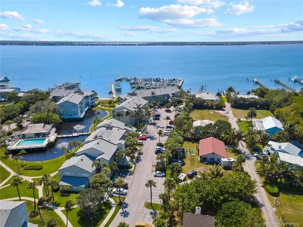 an aerial view of multiple house with ocean view