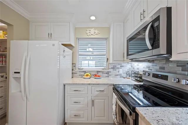 a view of a hallway with a couch and a flat screen tv