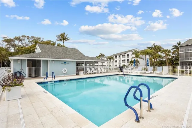 a view of a swimming pool with outdoor seating
