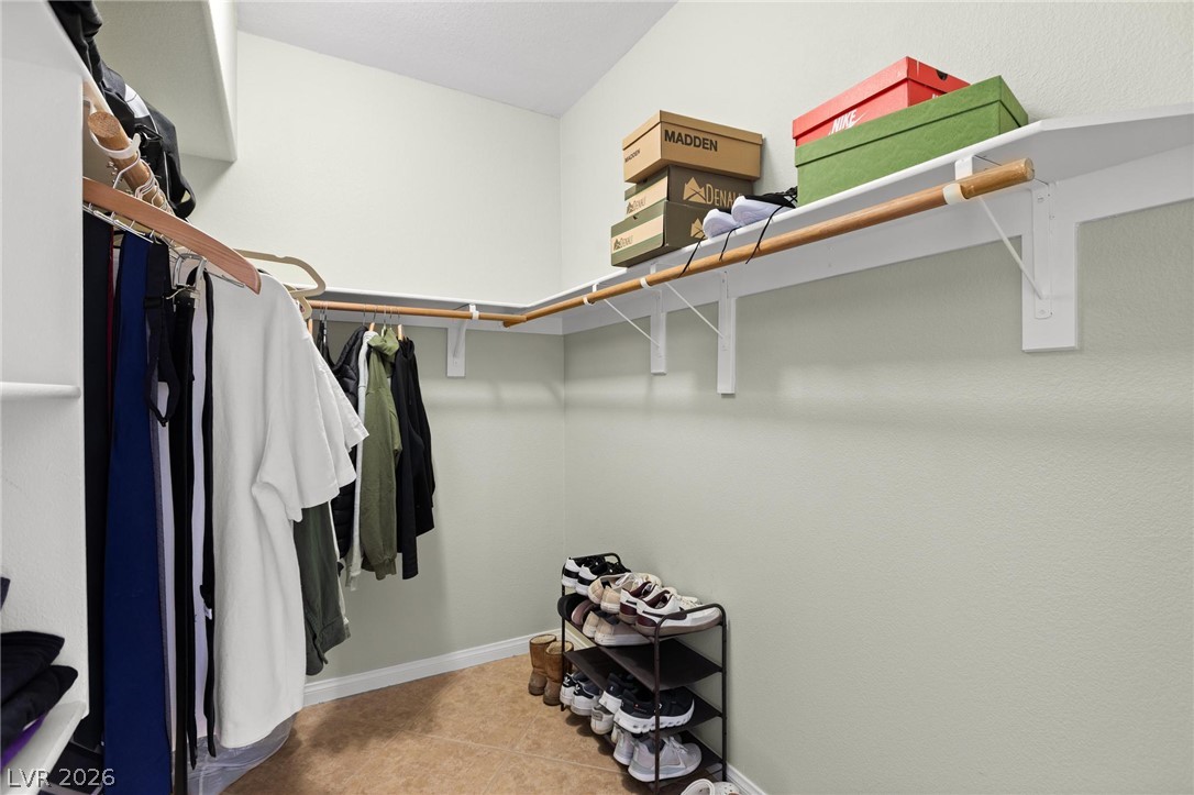 3238 Mystic Ridge Court Las Vegas, NV 89129 - Photo 13 of 31 Functional closet space offers ample storage with integrated shelving and hanging rods.