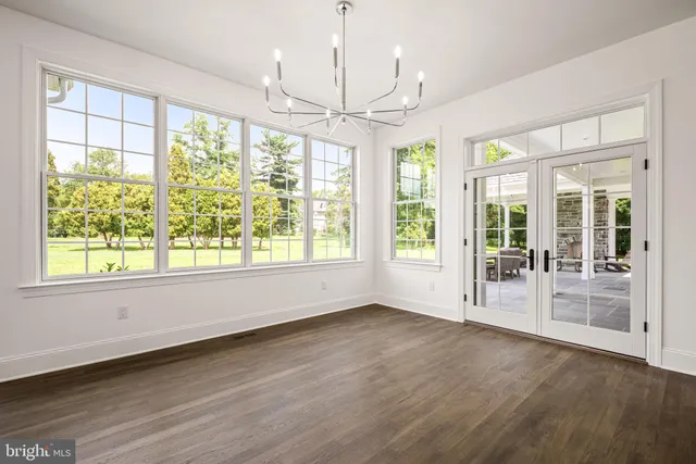 a spacious bedroom with a bed and a large window