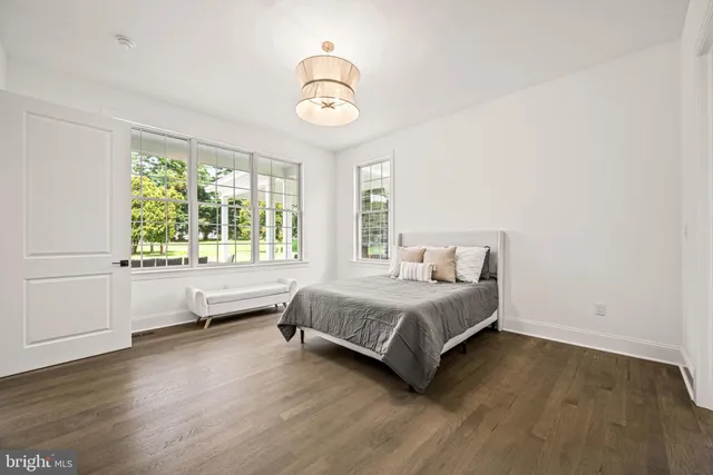 a spacious bedroom with a bed and a large window