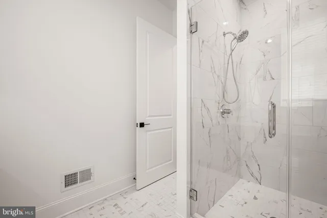 a spacious bathroom with double vanity a mirror a bathtub and shower