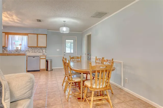 a view of a dining room with furniture and a chandelier