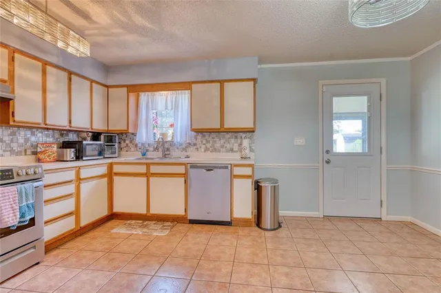 a kitchen with a stove a sink and a refrigerator