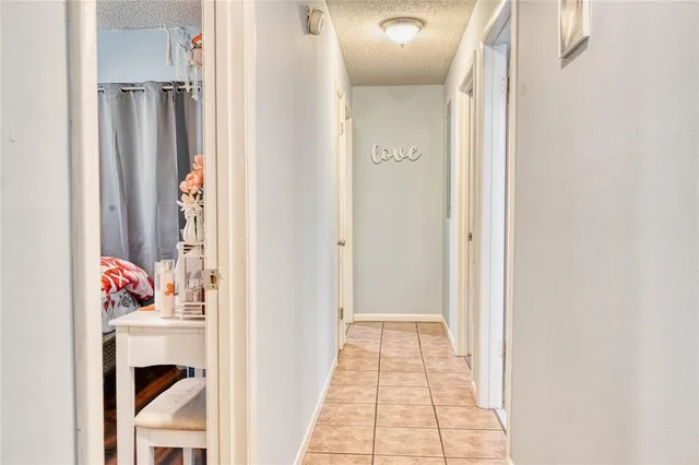 a view of a hallway with a white door and a window