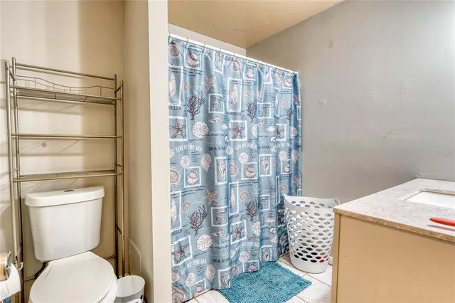 a bathroom with a toilet and shower
