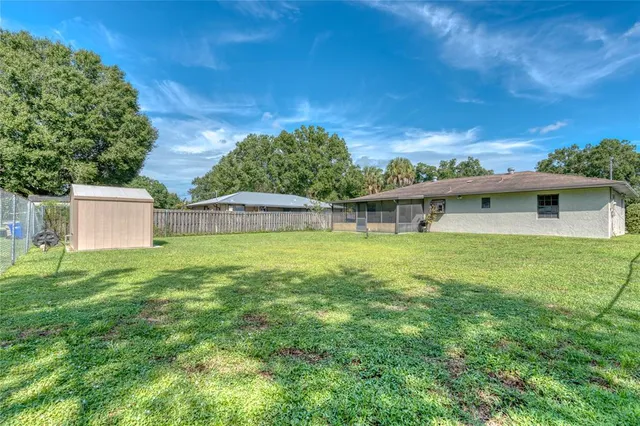 a view of a house with a backyard