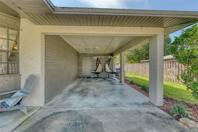 a view of a porch with furniture and garden