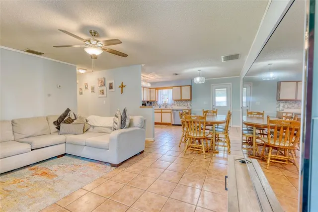 a living room with furniture and kitchen view