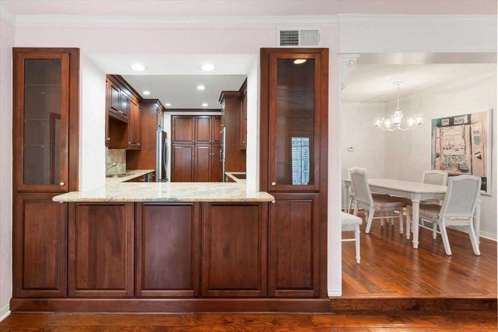 1109 Roaring Springs Road, Unit 1109 Fort Worth, TX 76114 - Photo 16 of 35 a kitchen with stainless steel appliances granite countertop a stove and a refrigerator with wooden floor