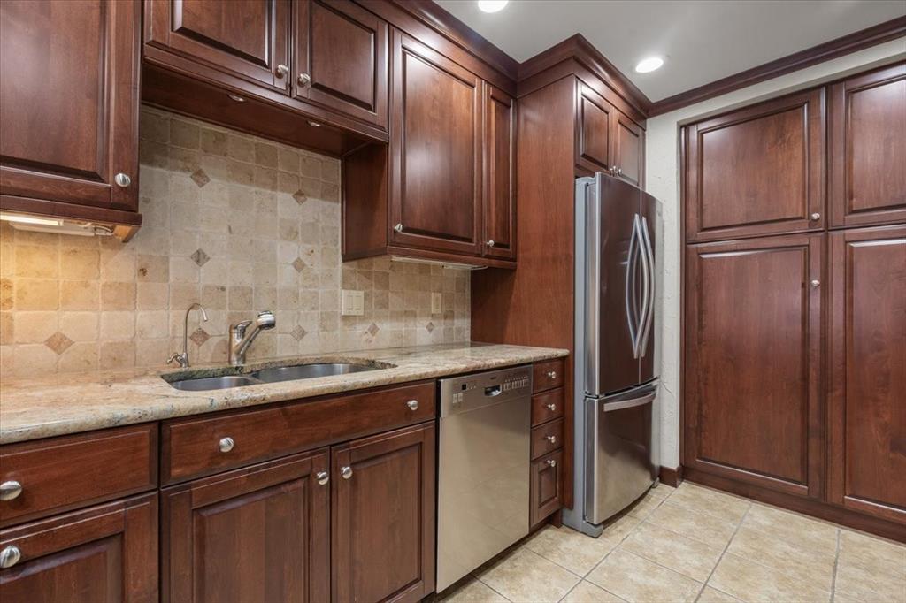 1109 Roaring Springs Road, Unit 1109 Fort Worth, TX 76114 - Photo 20 of 35 a kitchen with stainless steel appliances granite countertop a refrigerator and a sink