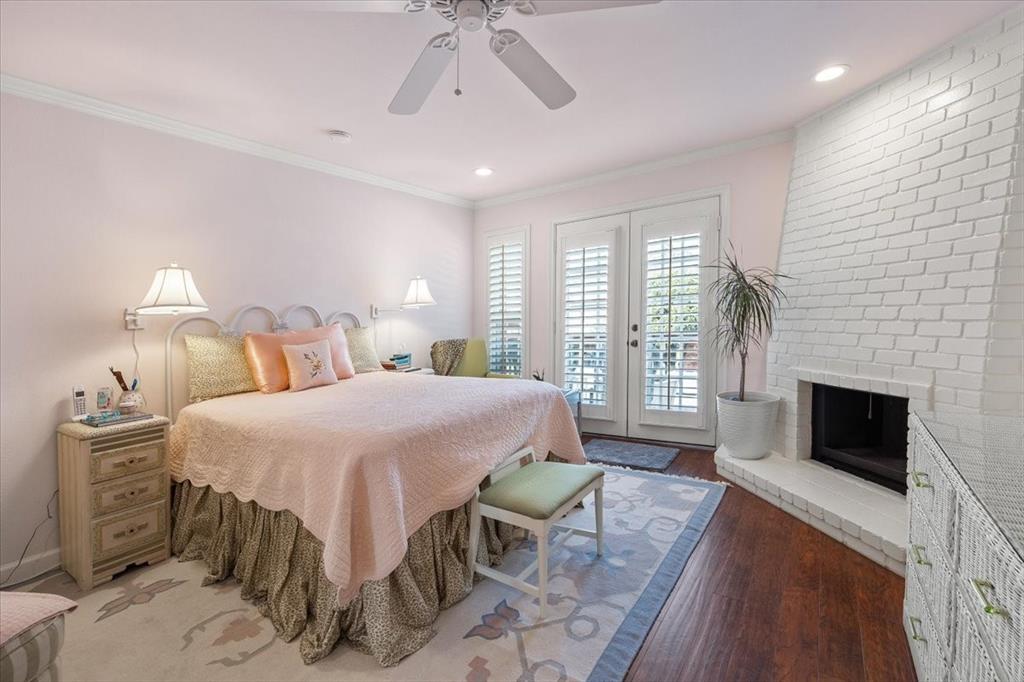 1109 Roaring Springs Road, Unit 1109 Fort Worth, TX 76114 - Photo 22 of 35 a spacious bedroom with a bed a fireplace and a flat tv screen