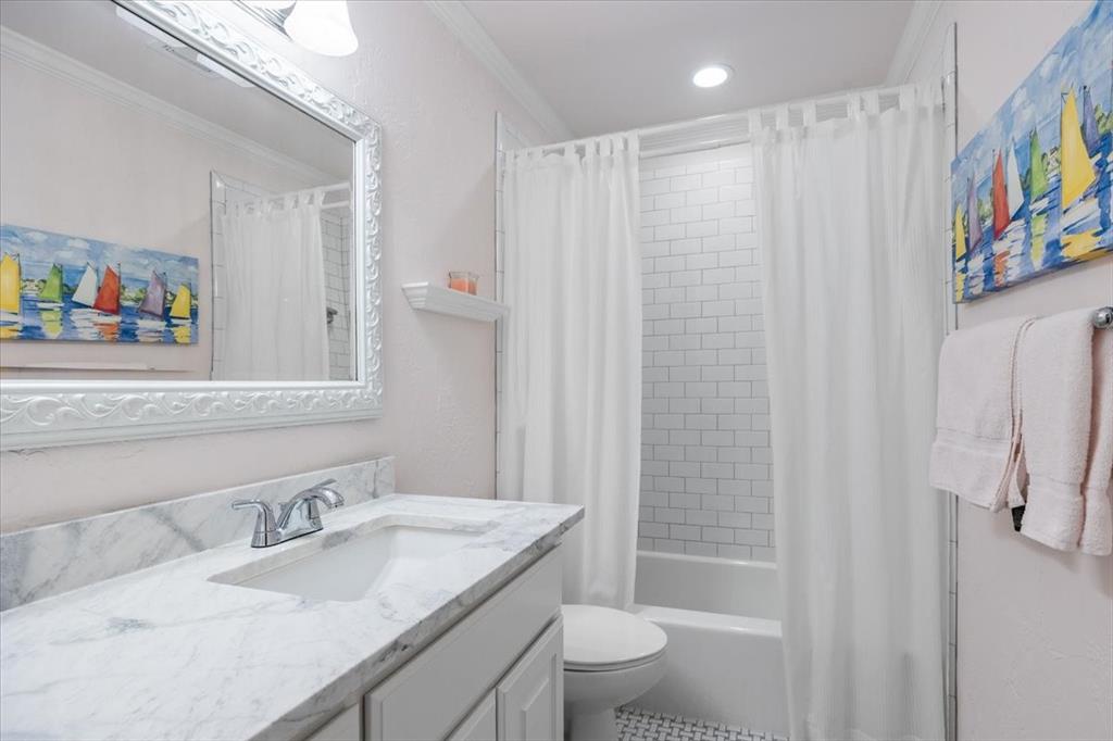 1109 Roaring Springs Road, Unit 1109 Fort Worth, TX 76114 - Photo 27 of 35 a bathroom with a granite countertop sink a toilet mirror and shower