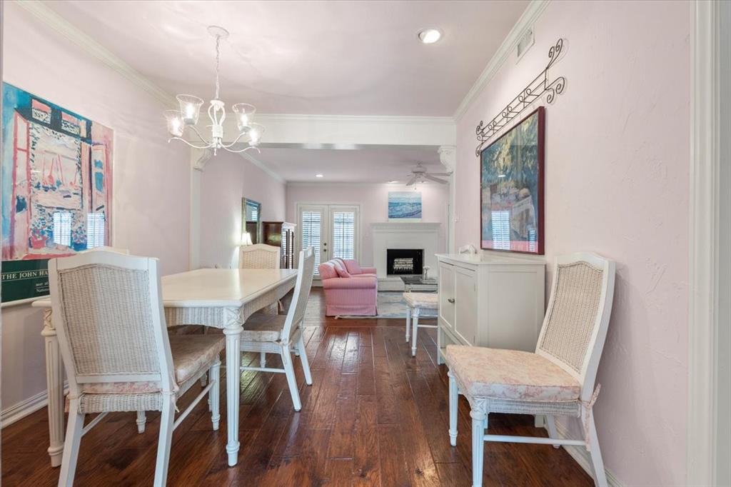 1109 Roaring Springs Road, Unit 1109 Fort Worth, TX 76114 - Photo 8 of 35 a view of a dining room with furniture a chandelier and wooden floor