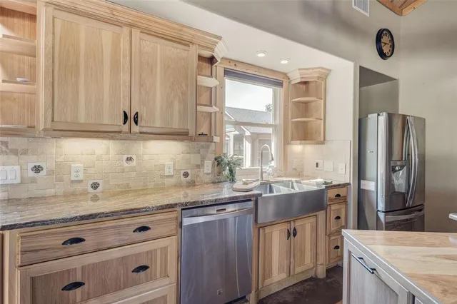 a large white kitchen with cabinets