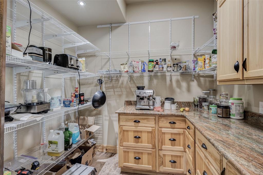 423 Hcr 1439 Covington, TX 76636 - Photo 15 of 40 a kitchen with stainless steel appliances granite countertop a stove a sink and a white cabinets
