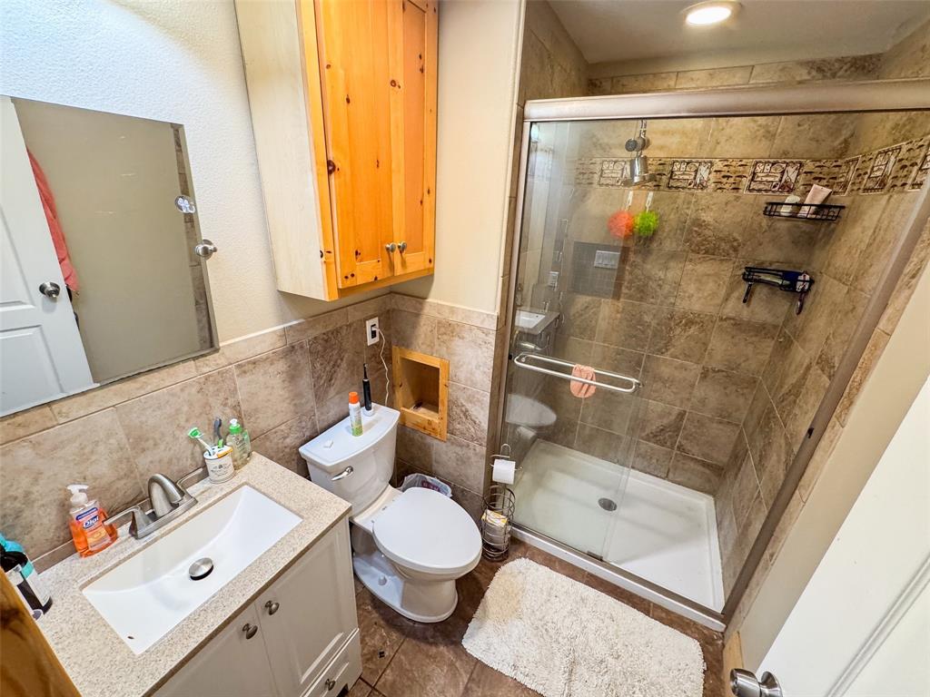 423 Hcr 1439 Covington, TX 76636 - Photo 27 of 40 a bathroom with a sink toilet and shower