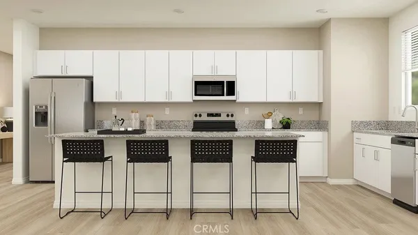 a kitchen with stainless steel appliances a stove a sink cabinets and a refrigerator