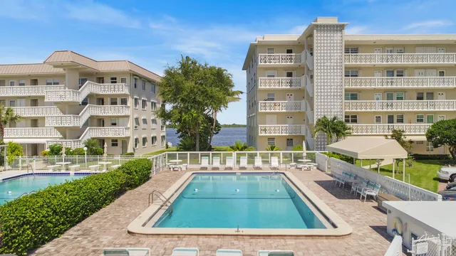 a view of a building with garden space and sitting area