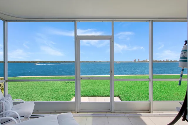 a view of a yard with a floor to ceiling window