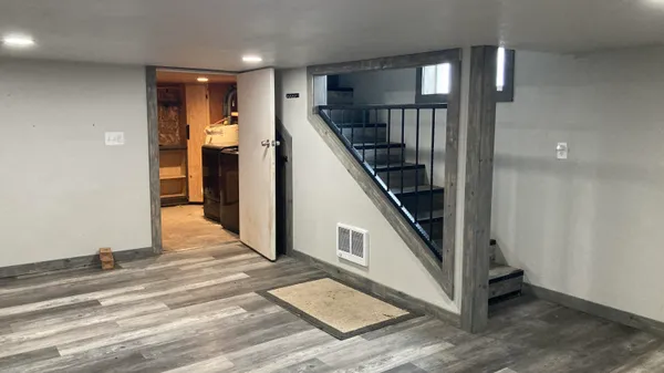 a view of entryway with stairs and wooden floor