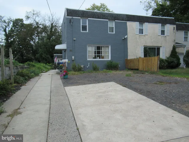 a backyard of a house with plants and trees