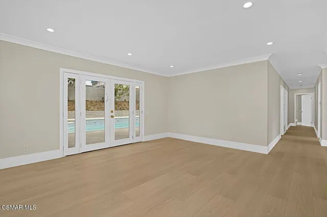 a view of an empty room with glass door