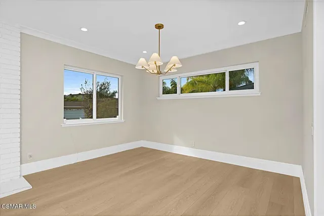 a front view of a house with wooden floor chandelier and a window
