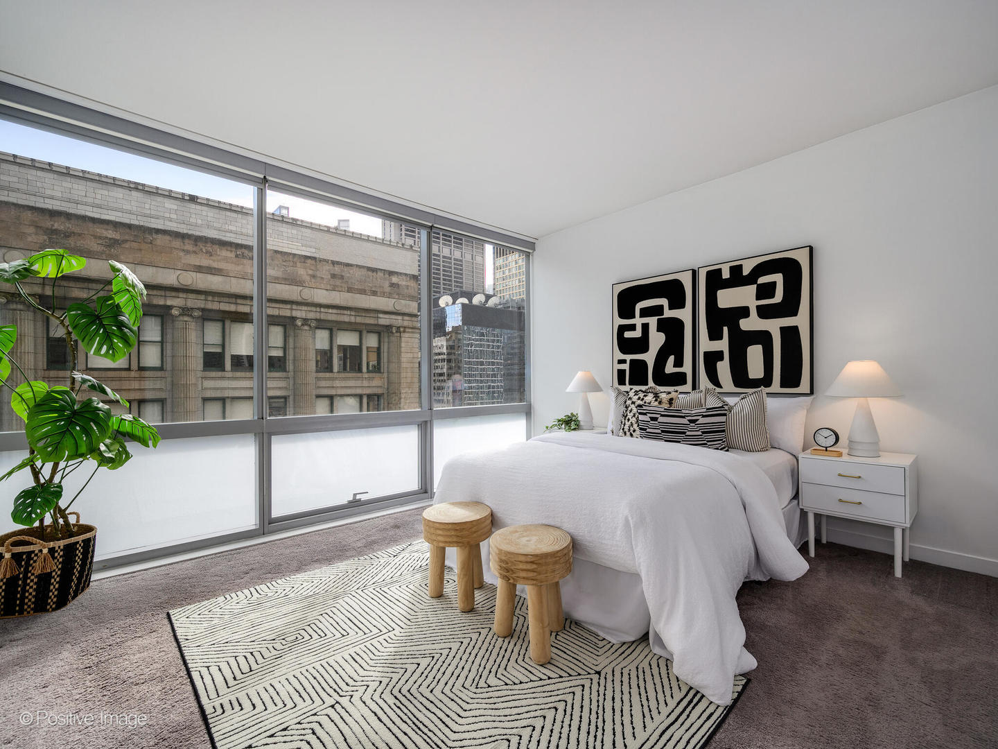 8 East Randolph Street, Unit 1208 Chicago, IL 60601 - Photo 11 of 27 a bedroom with a large bed and a potted plant