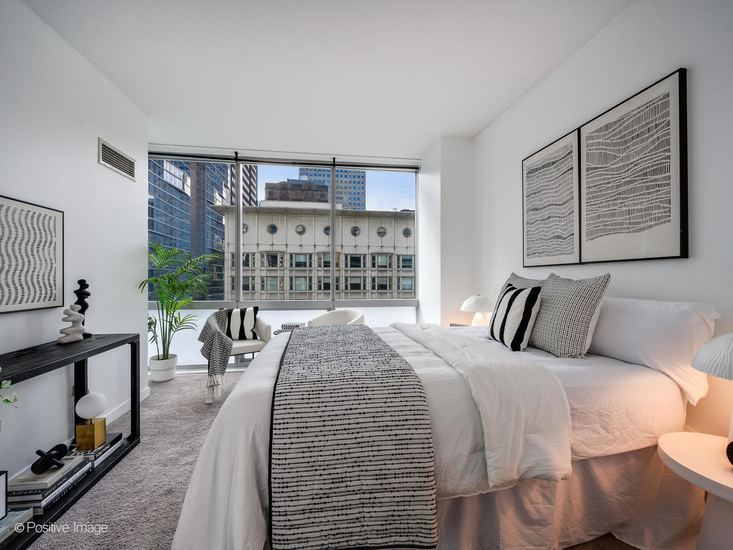 8 East Randolph Street, Unit 1208 Chicago, IL 60601 - Photo 16 of 27 a bed room with a bed and a large window