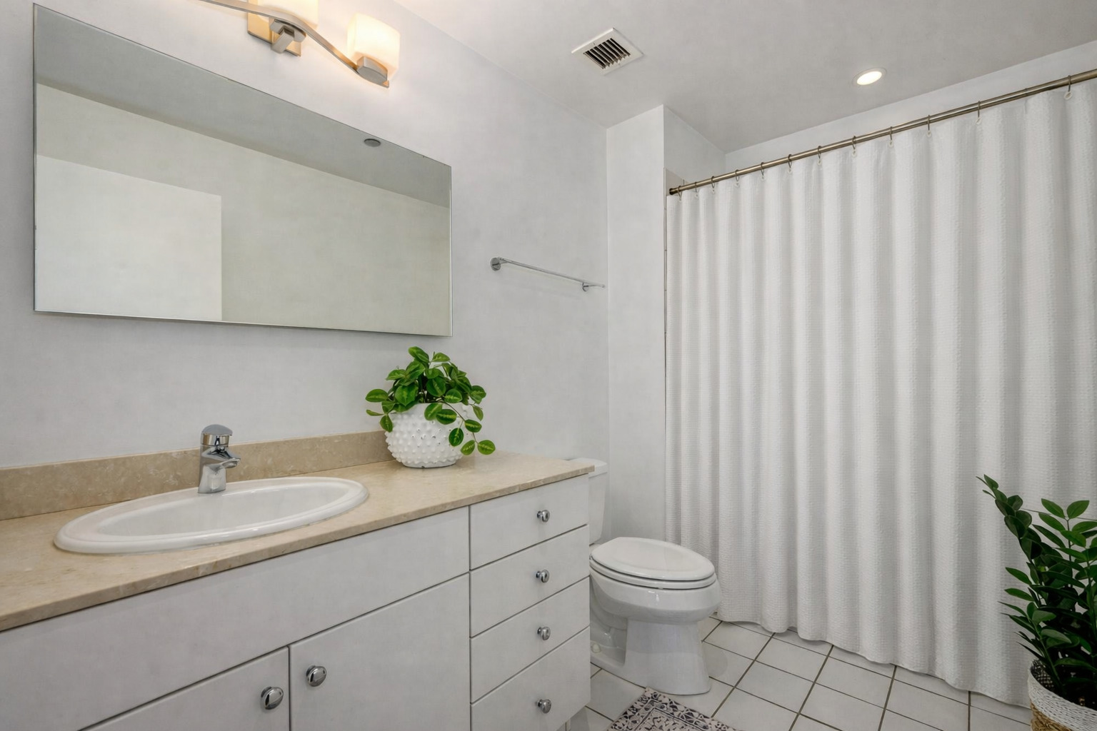 8 East Randolph Street, Unit 1208 Chicago, IL 60601 - Photo 17 of 27 a bathroom with a granite countertop sink a toilet and a mirror