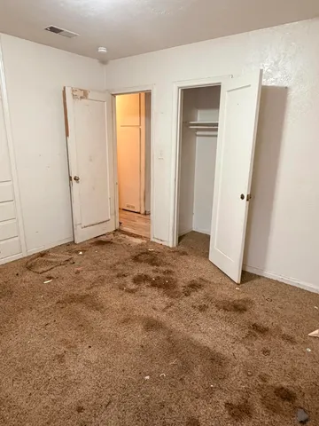 an empty room with closet area