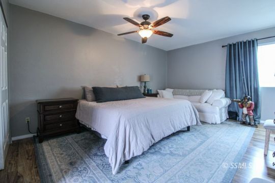 708 West Perdew Avenue Ridgecrest, CA 93555 - Photo 23 of 37 a bedroom with a bed and a chandelier