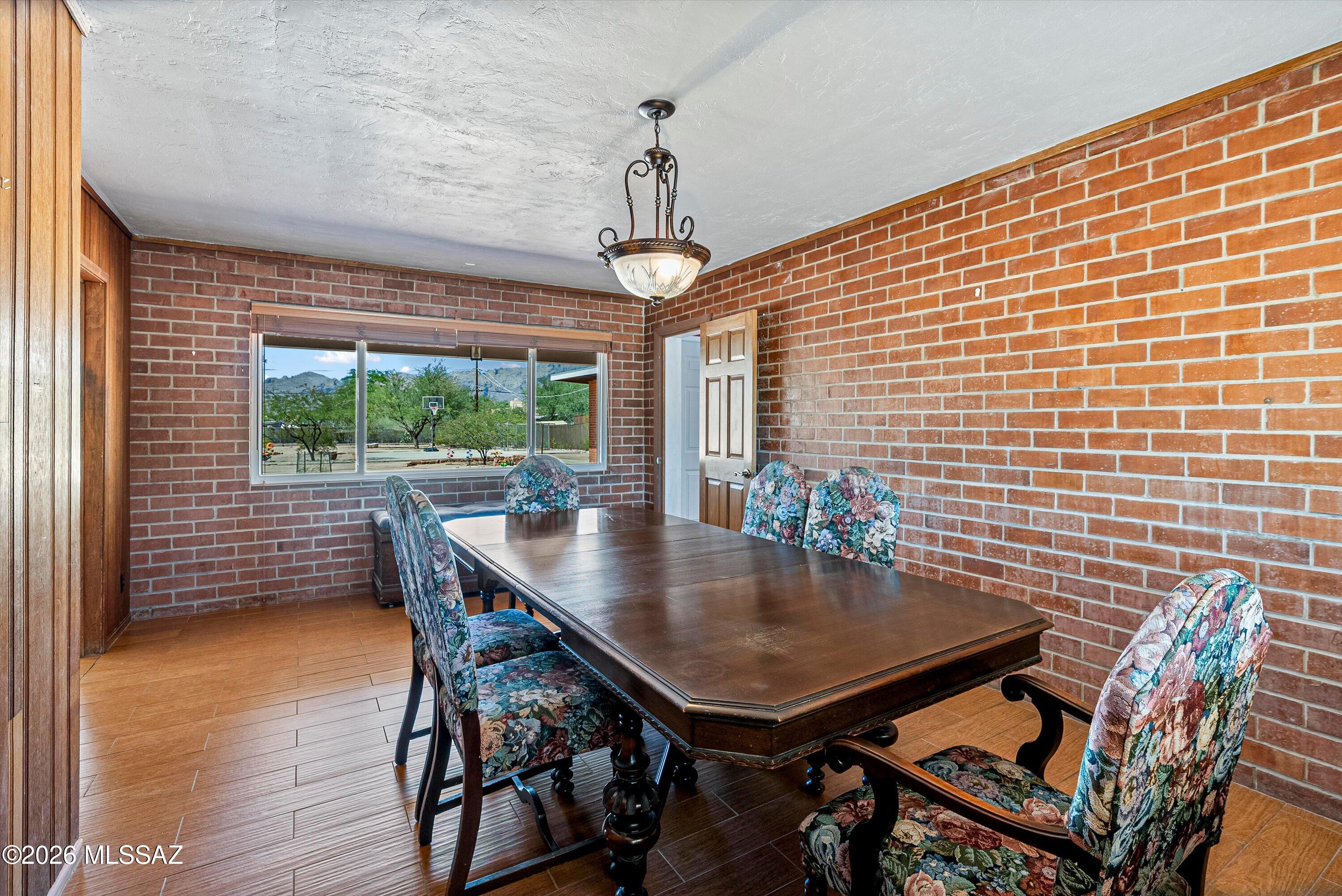 2107 East Lind Road Tucson, AZ 85719 - Photo 11 of 43 a view of a dining room with furniture window and wooden floor