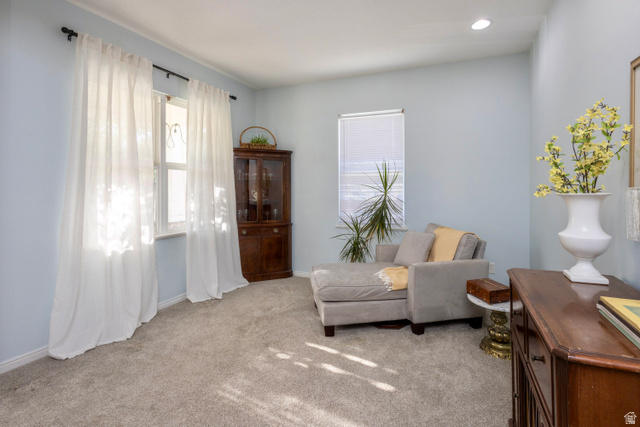 11751 Lake Run Road South Jordan, UT 84009 - Photo 5 of 38 Carpeted room featuring light blue walls, a large window with white sheer curtains, and a smaller window with a white blind