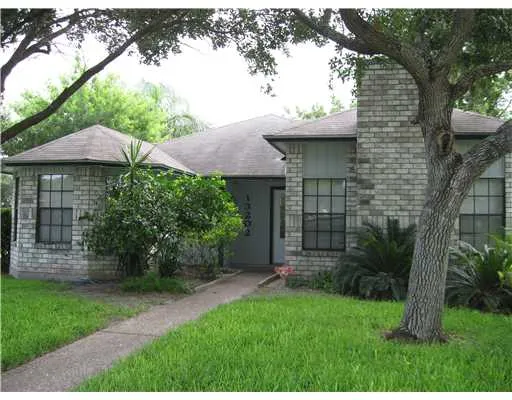 a view of a back yard of the house and a garden