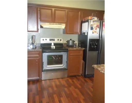 a kitchen with a refrigerator and a stove