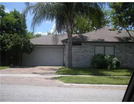 a house that has a tree in front of it