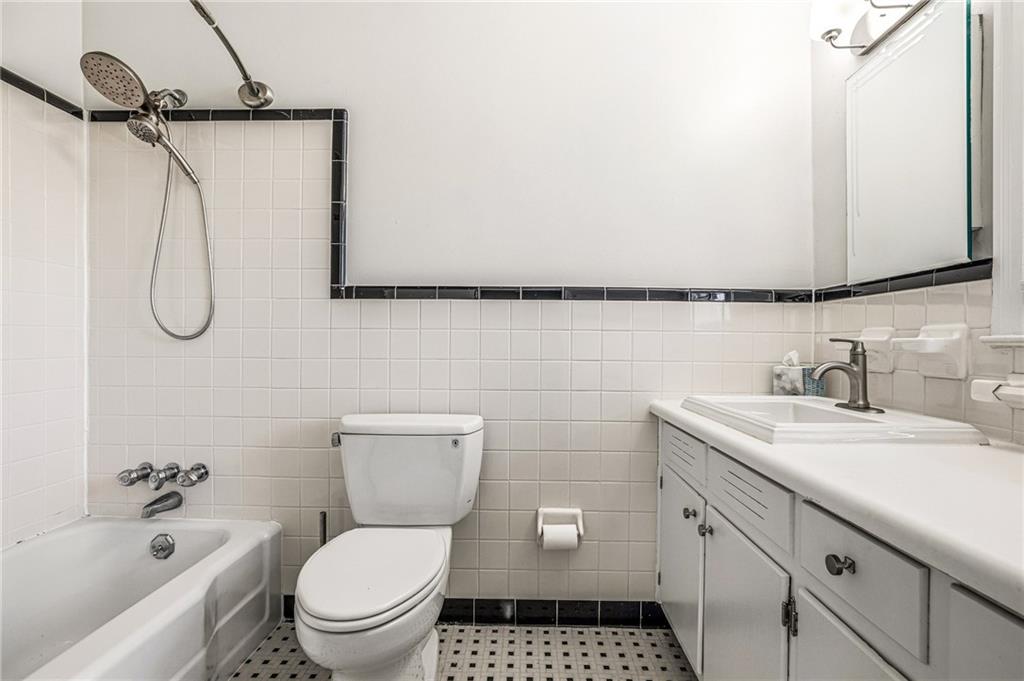 3694 Peachtree Road Northeast, Unit A4 Atlanta, GA 30319 - Photo 11 of 17 a bathroom with a granite countertop sink toilet and shower