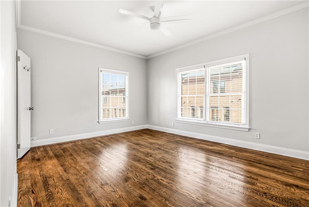 3694 Peachtree Road Northeast, Unit A4 Atlanta, GA 30319 - Photo 12 of 17 a view of an empty room with wooden floor and a window