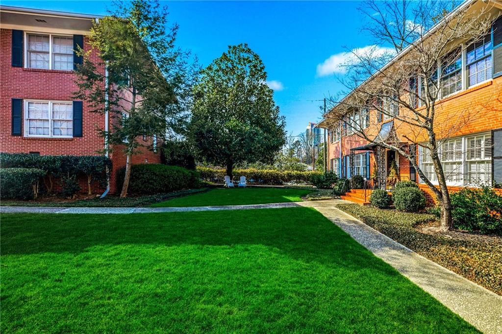 3694 Peachtree Road Northeast, Unit A4 Atlanta, GA 30319 - Photo 15 of 17 a front view of a house with a yard