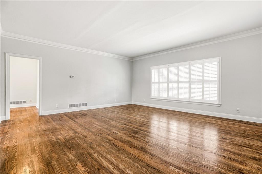 3694 Peachtree Road Northeast, Unit A4 Atlanta, GA 30319 - Photo 4 of 17 an empty room with wooden floor and windows