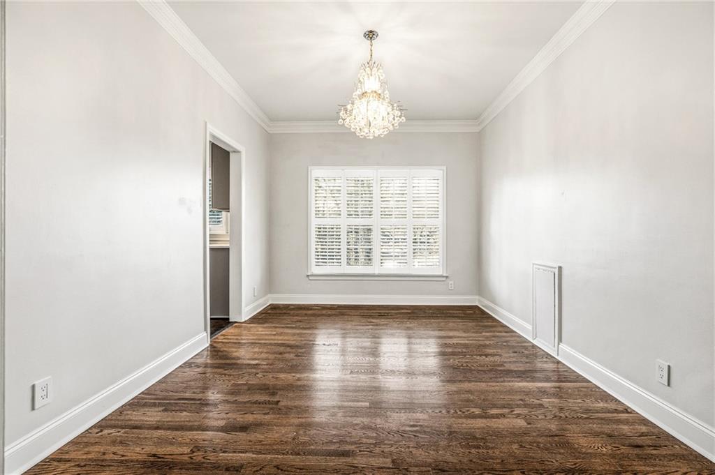 3694 Peachtree Road Northeast, Unit A4 Atlanta, GA 30319 - Photo 5 of 17 an empty room with wooden floor chandelier and windows