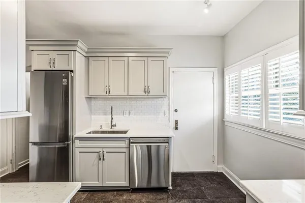 a kitchen with a refrigerator sink and cabinets
