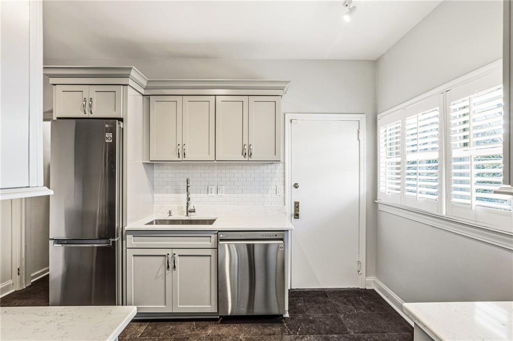 3694 Peachtree Road Northeast, Unit A4 Atlanta, GA 30319 - Photo 7 of 17 a kitchen with a refrigerator sink and cabinets